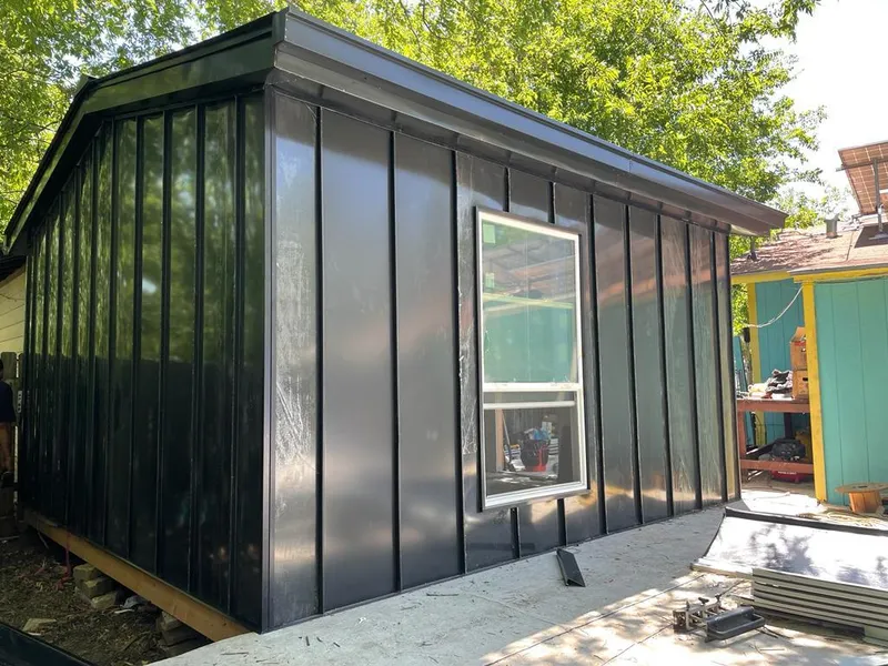 Black standing seam metal wall panels for Roof Inspection in Dent