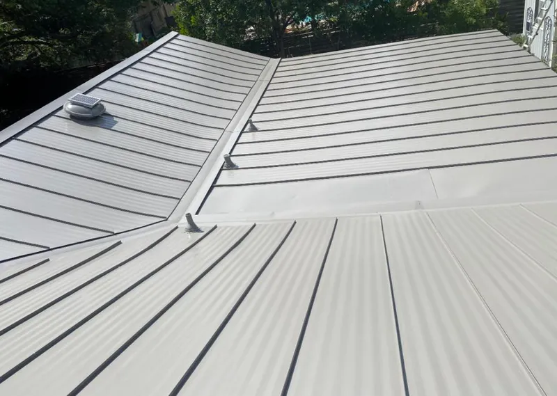 Solar attic fan installed on a metal roof for Roof Ventilation in Dent